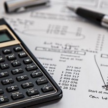 Calculator and pen on sheet